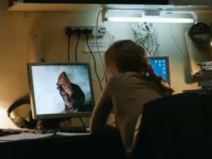 Woman looking at image of a torture victim on her computer