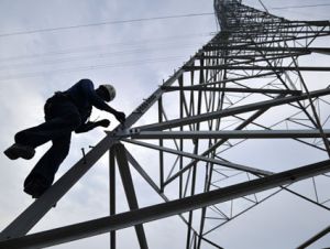 Worker climbs tower.
