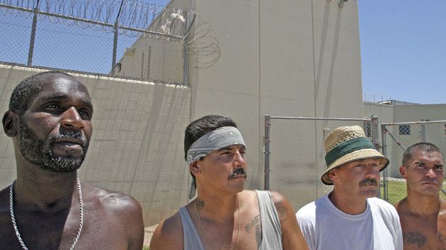 Four prisoners standing in a row