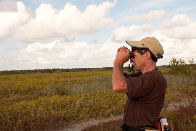 John Davis looking through binoculars