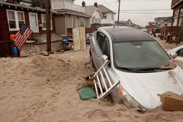 a car half-buried in the sand