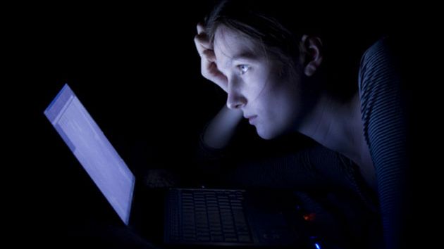 Woman on her computer at night