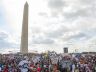 Washington monument with protestors around it