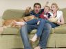 family watching movie on couch