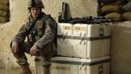 A soldier sitting on crates