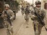 Soldiers walking towards the camera with guns