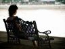 woman sitting alone on a bench