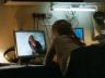 Woman looking at image of a torture victim on her computer